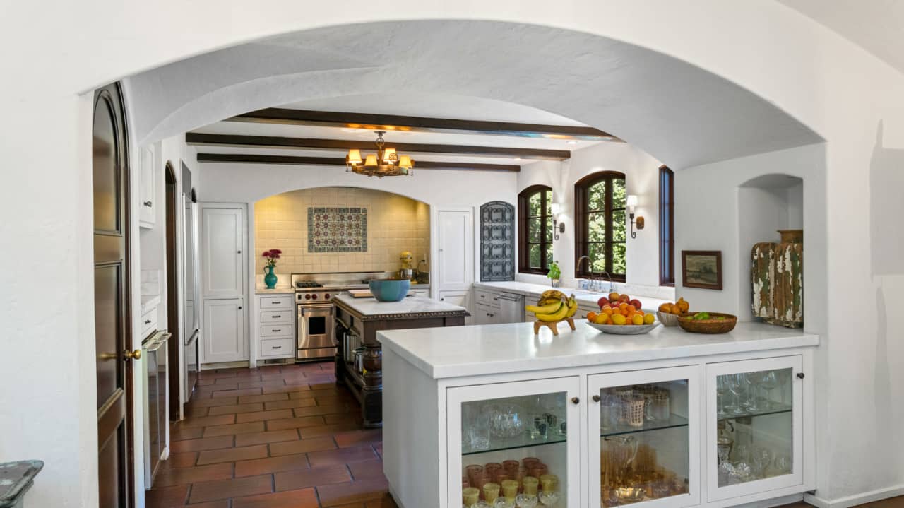 The home's open kitchen leads into an informal dining and living space.