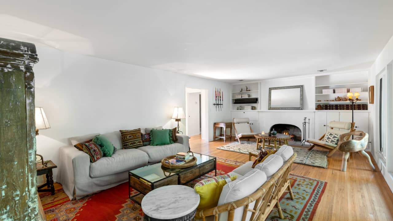 The guest house living room has a fireplace.