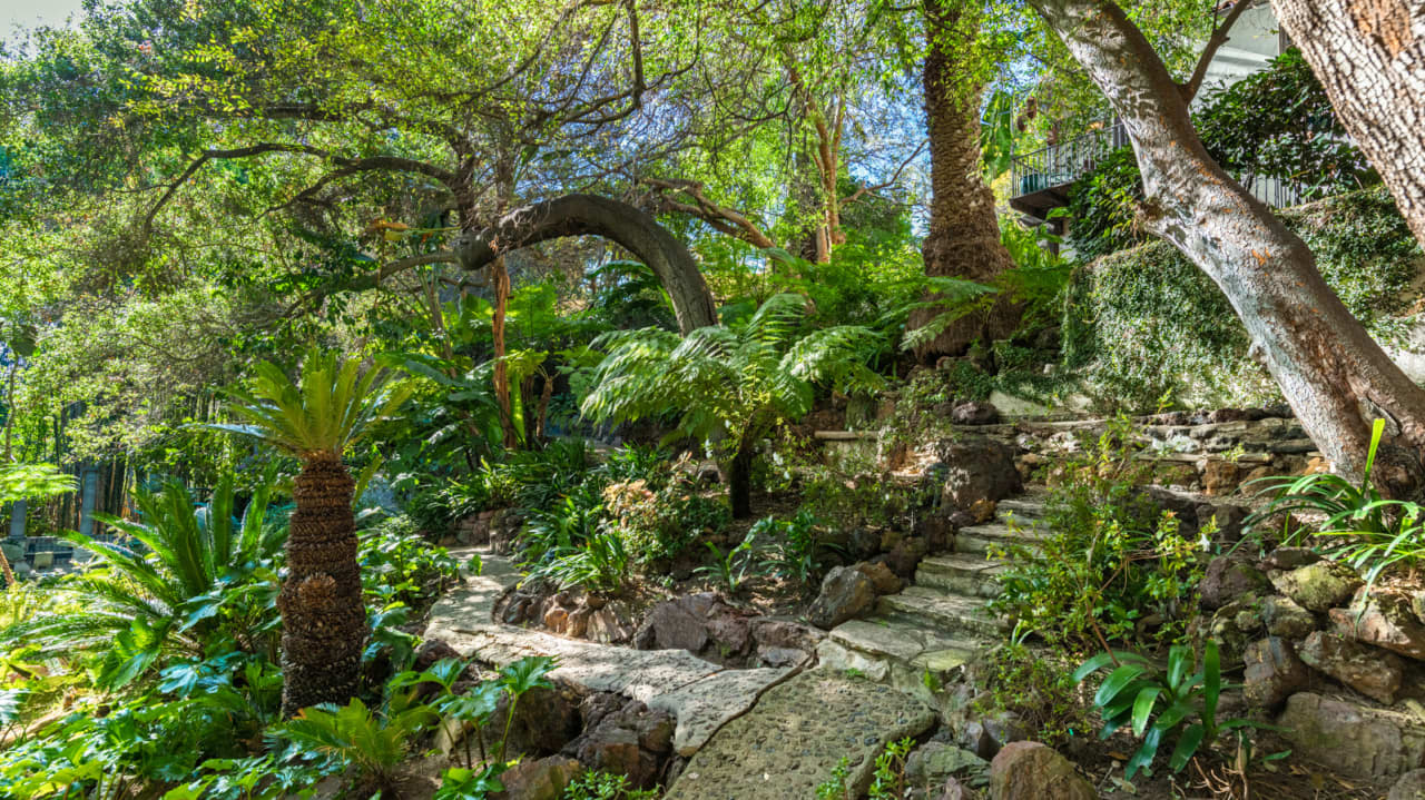 The paths also lead to a "hidden" tearoom, as well as a footbridge over the property's bordering creek.