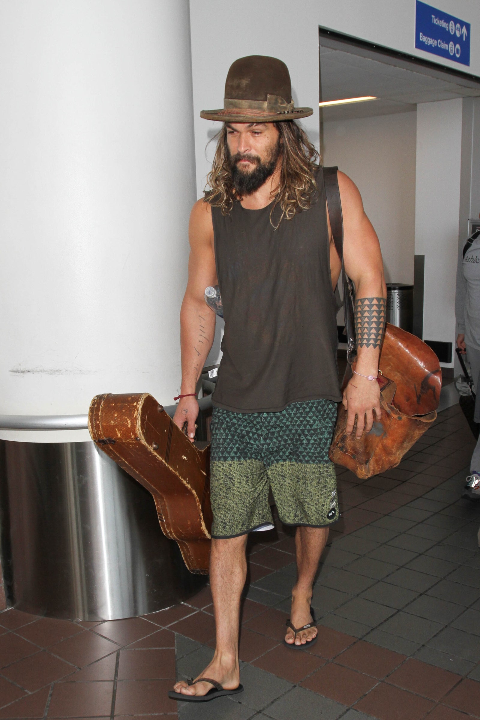 This image may contain Jason Momoa Human Person Clothing Apparel Hat Shorts and Skin