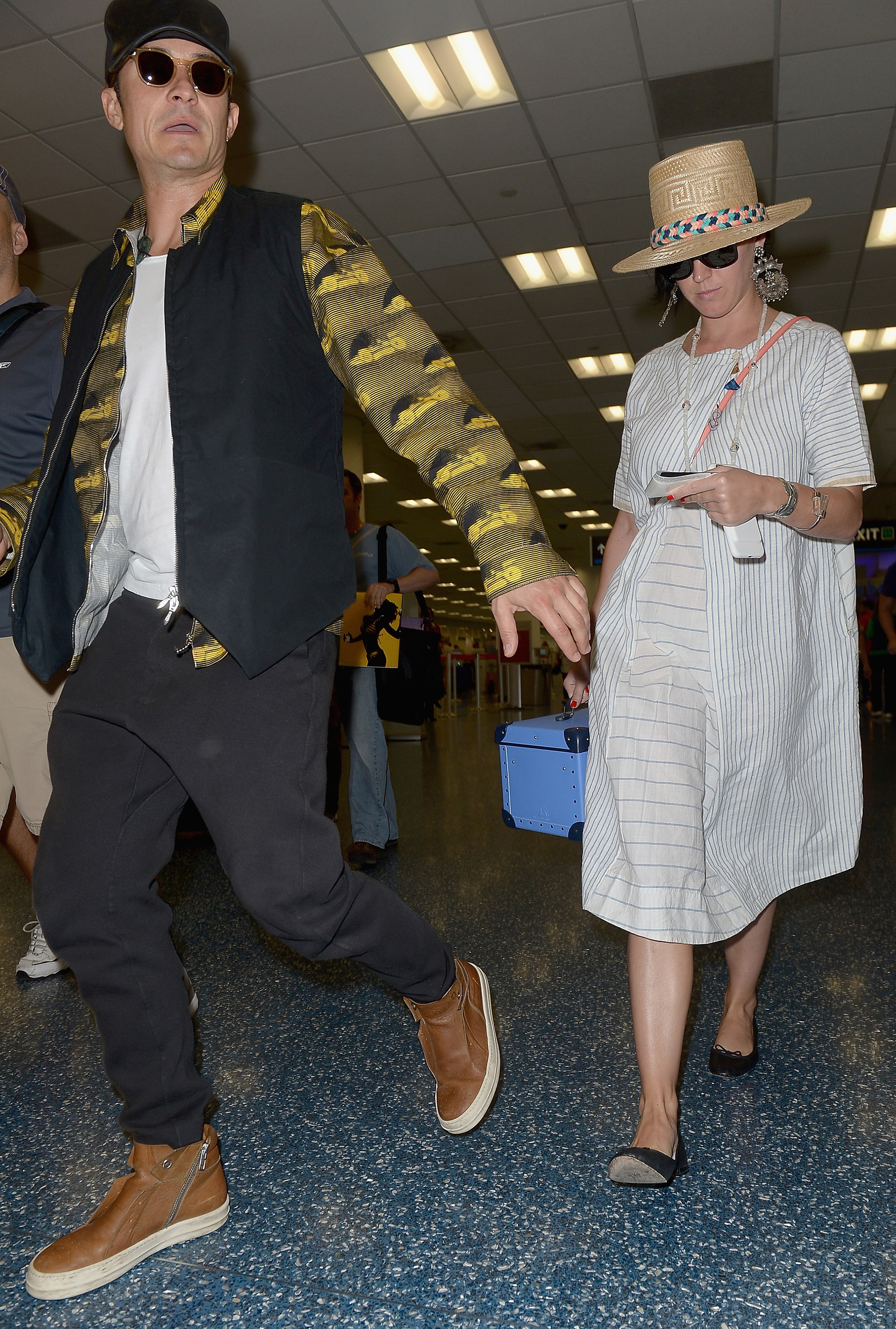 Orlando Bloom and Katy Perry walking in an airport in 2016