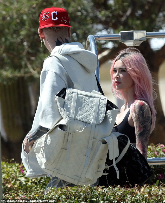 Megan's outfit showcased the large sleeve tattoo on her arm — a black and gray illustration of a phoenix in flight with blooming flowers drawn in red ink — which she debuted last month