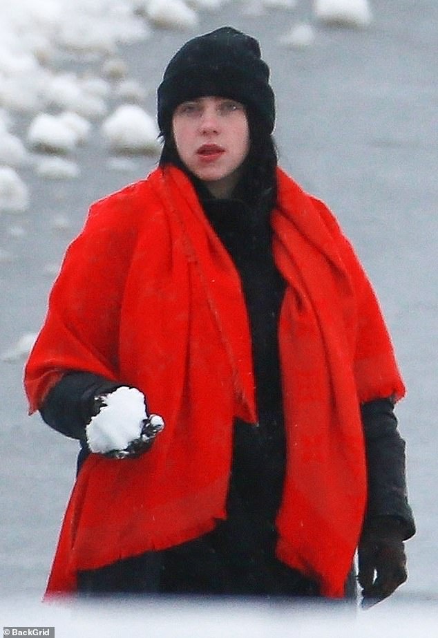 It's cold out there: For her trip out, she bundled up with a black beanie and a pair of gloves to keep herself warm