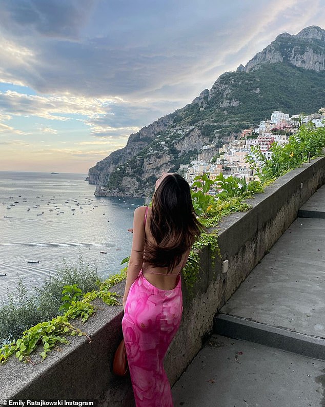 Stylish: As she posed in her skintight pink frock with a darling thigh-high slit, the new mom let her bouncy brunette locks cascade freely down her back