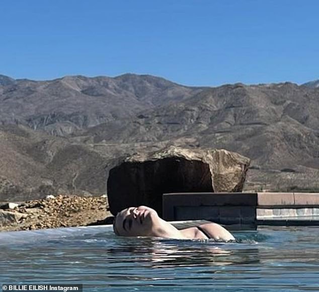 In the swim: The Bag Guy crooner was also seen in the lavish swimming pool as she took a dip in a black swimsuit in a post shared to Instagram on Wednesday