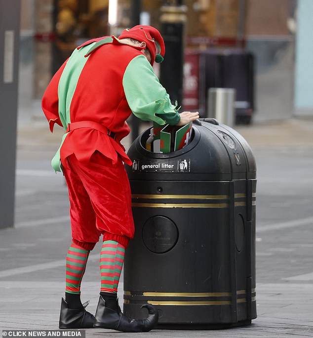 Following the chat on the phone, he folded up the large sale sign and pushed it into a public bin