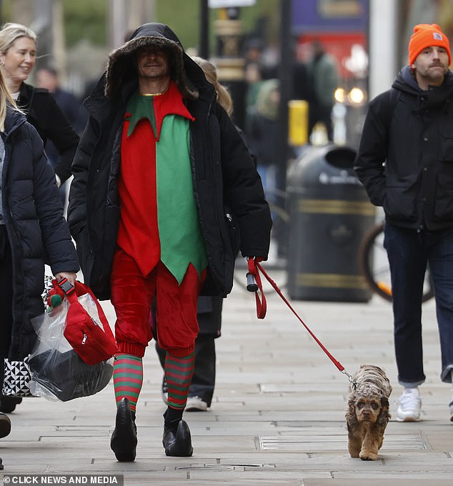 Ahead of filming, Orlando hid his face under a long black hooded coat as he arrived on set walking a dog