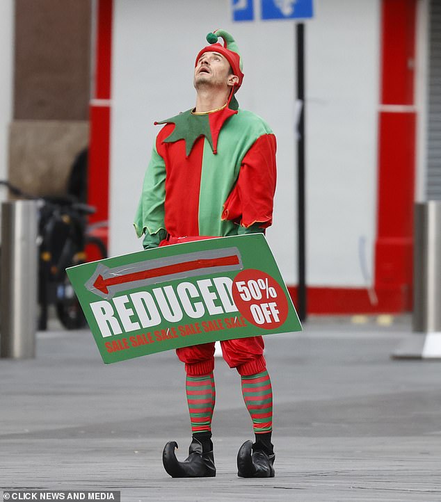 Orlando looked frustrated while holding the sign up as he looked up at the sky