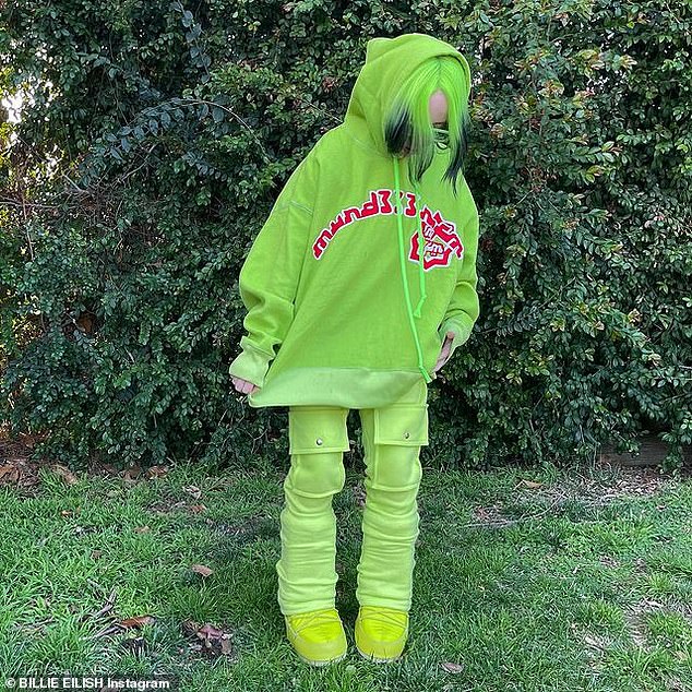 It all matches: The singer, 19, posed in a head-to-toe neon green ensemble and showed off her freshly dyed bright green hair with black ends for the snaps taken in a garden