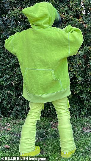 She wore the pants over matching neon green snow boots