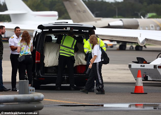 Members of airport staff were seen fetching her belongings from the vehicle