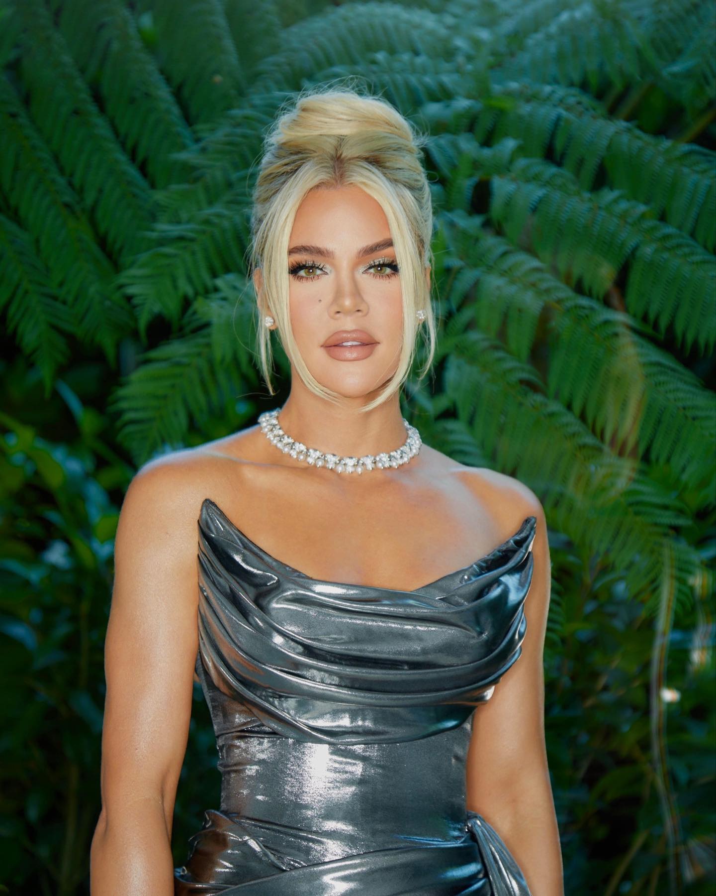 Khloe Kardashian dropped jaws as she donned a silver gown at a friend's wedding