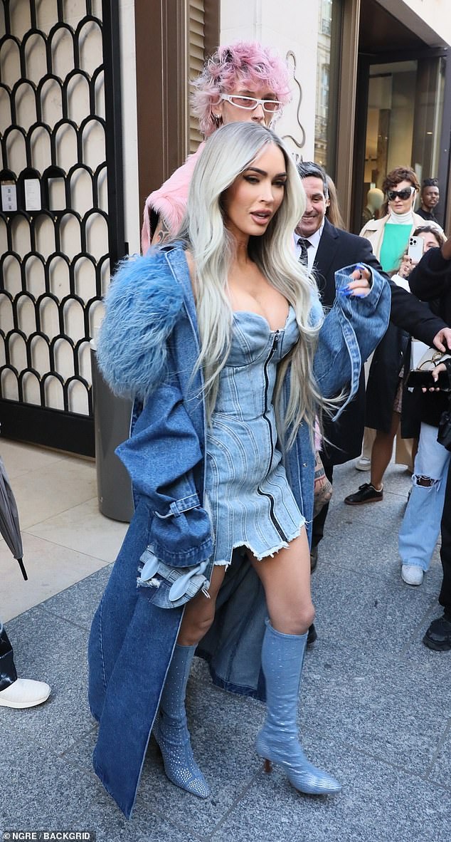 Quirky: The actress made sure to turn heads in the busty denim mini dress as she left her hotel in the French capital hand-in-hand with her shirtless beau