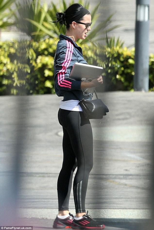 Sporty: Katy appeared to have come straight from the gym, wearing a pair of form-fitting leggings, which accentuated her slim figure, and a navy and pink zip-up Adidas jacket