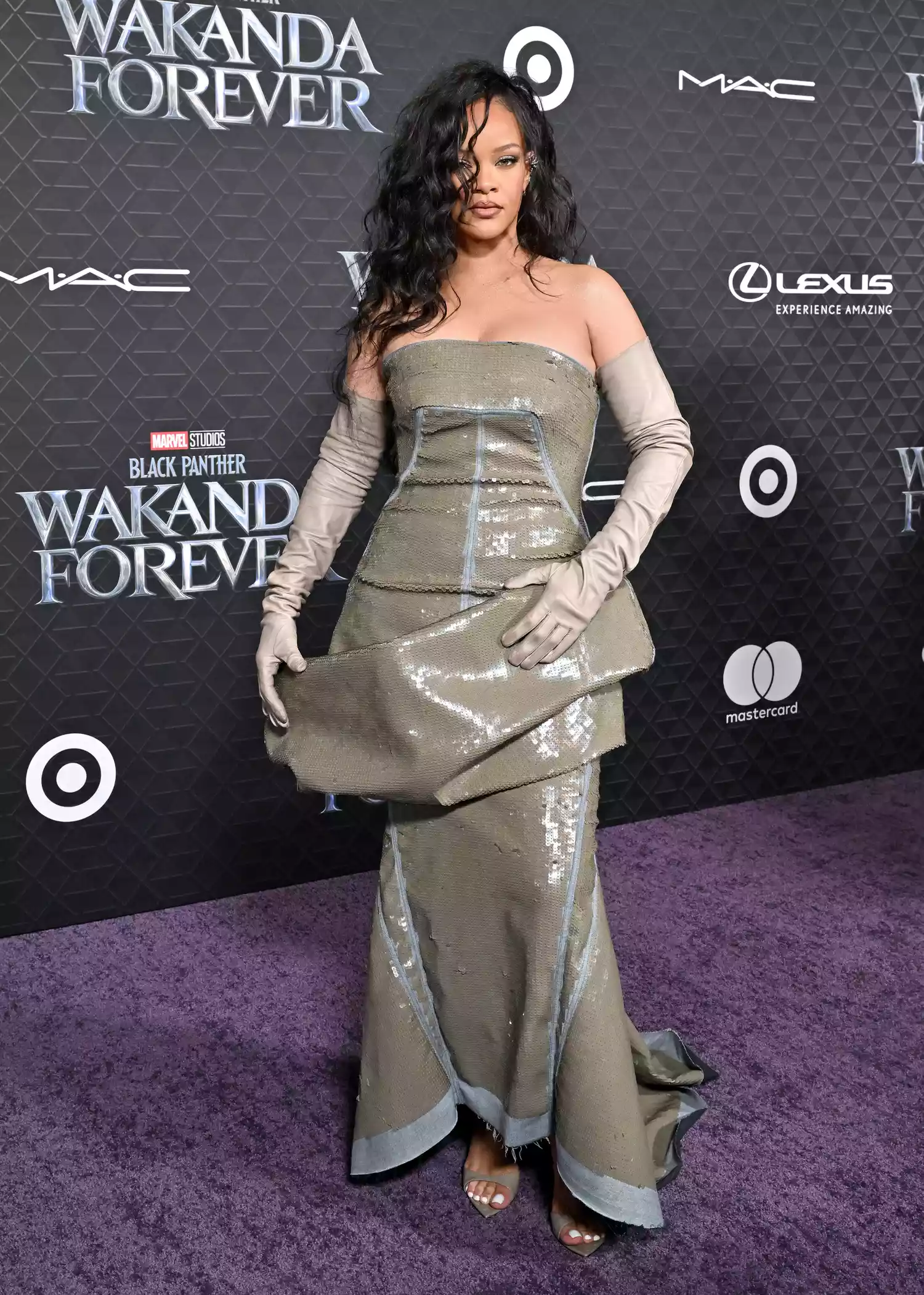 Rihanna in a strapless gray dress with opera gloves