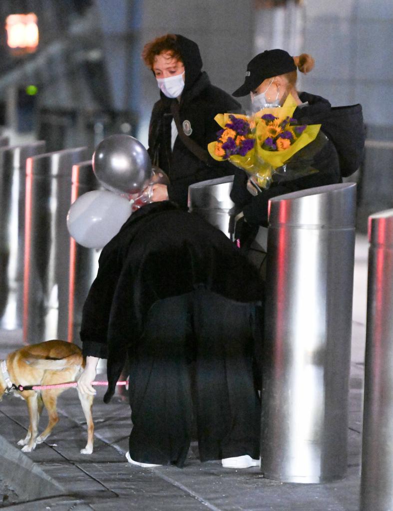 Ariana Grande and Ethan Slater hold hands, carry gifts at NYC airport