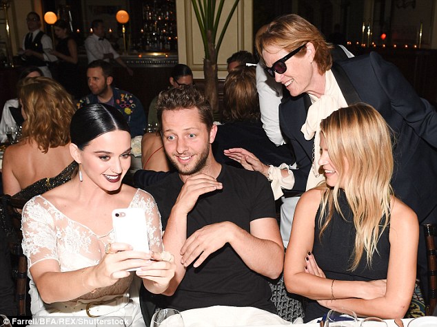 Snap happy: Katy wanted evidence as he snapped selfies with the cake and her pals 