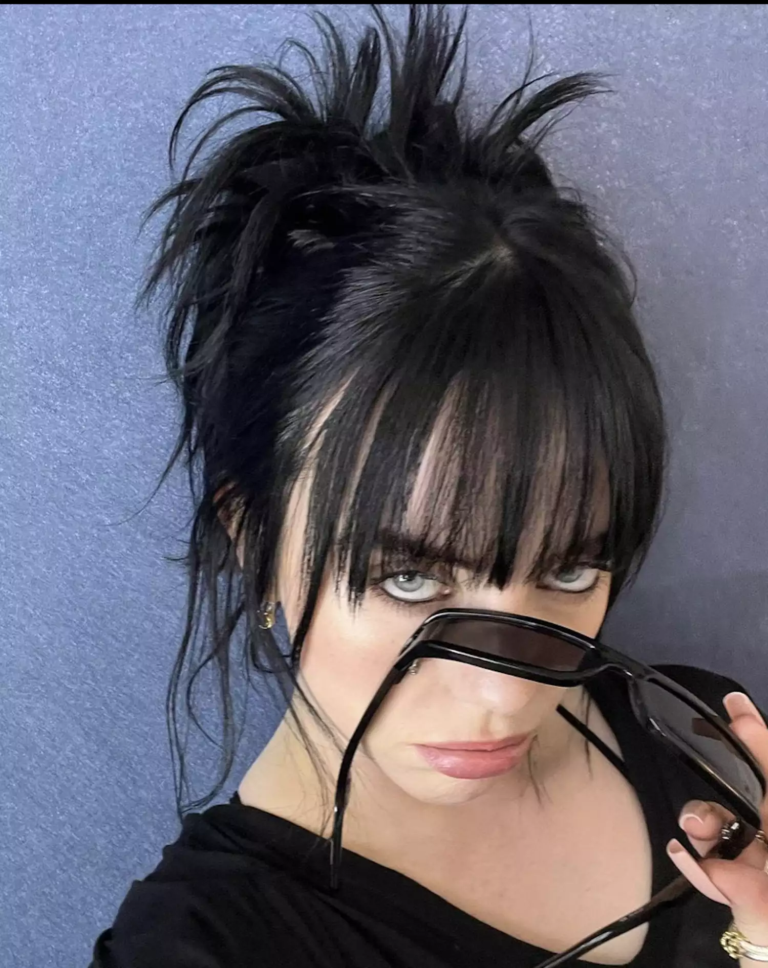 Billie Eilish in messy bun with bangs