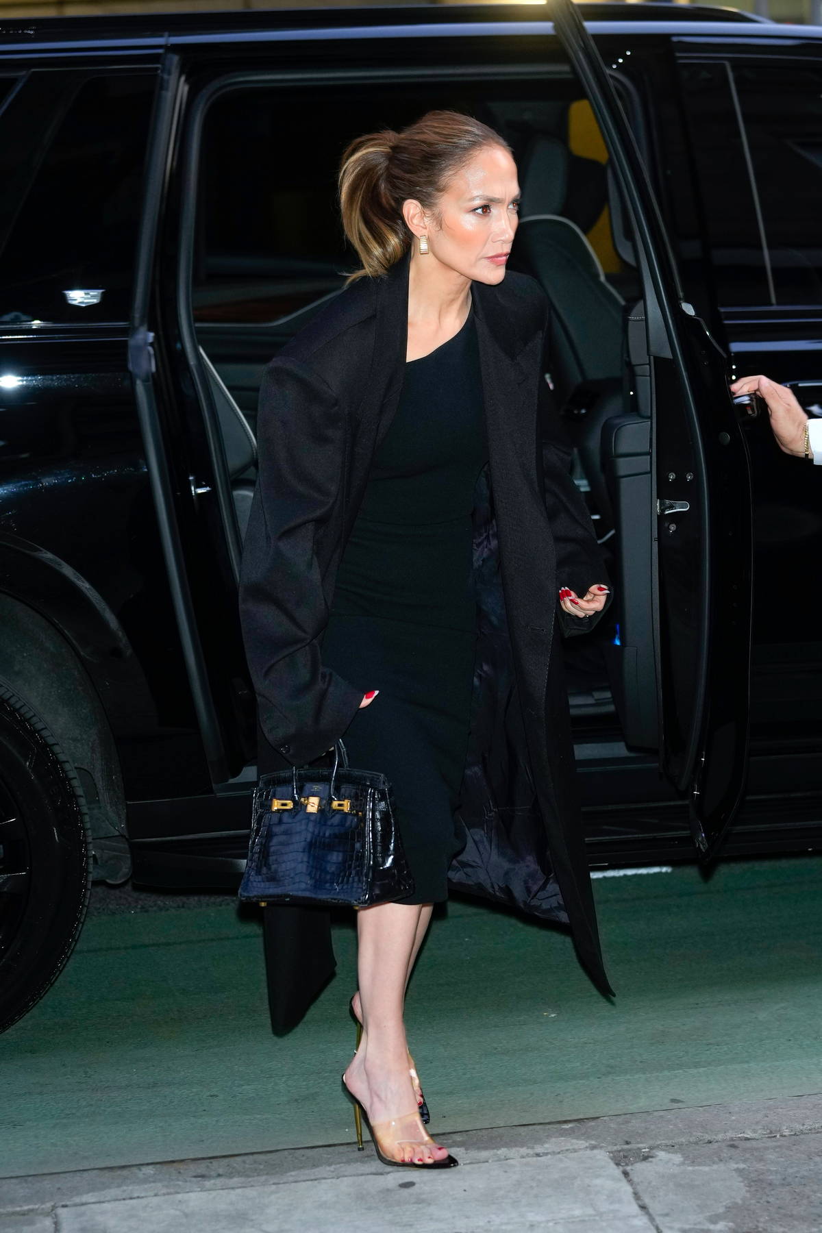 Jennifer Lopez looks stunning in a black dress with a matching coat while  heading out to dinner in New York City-210424_7