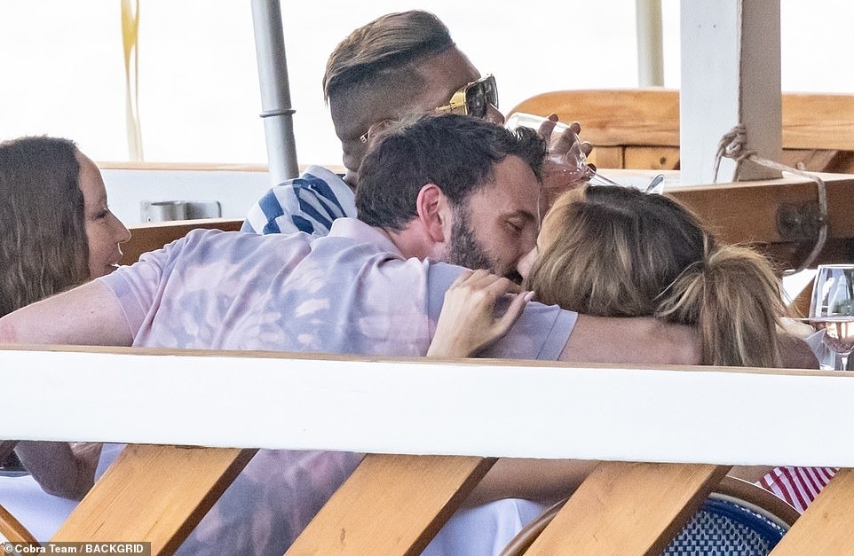 Table smooches: Ben wrapped an arm around Jennifer while they sat next to each other