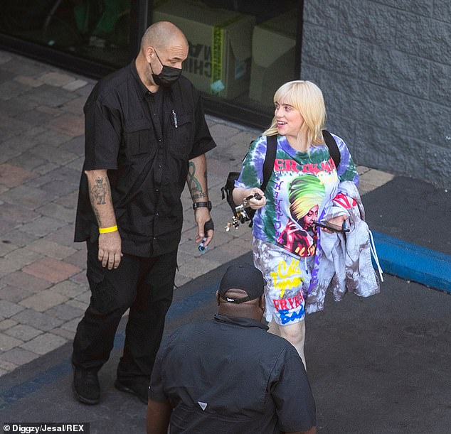 Relaxed: The star seemed in good spirits as she had a friendly chat with a security guard before hopping into her car