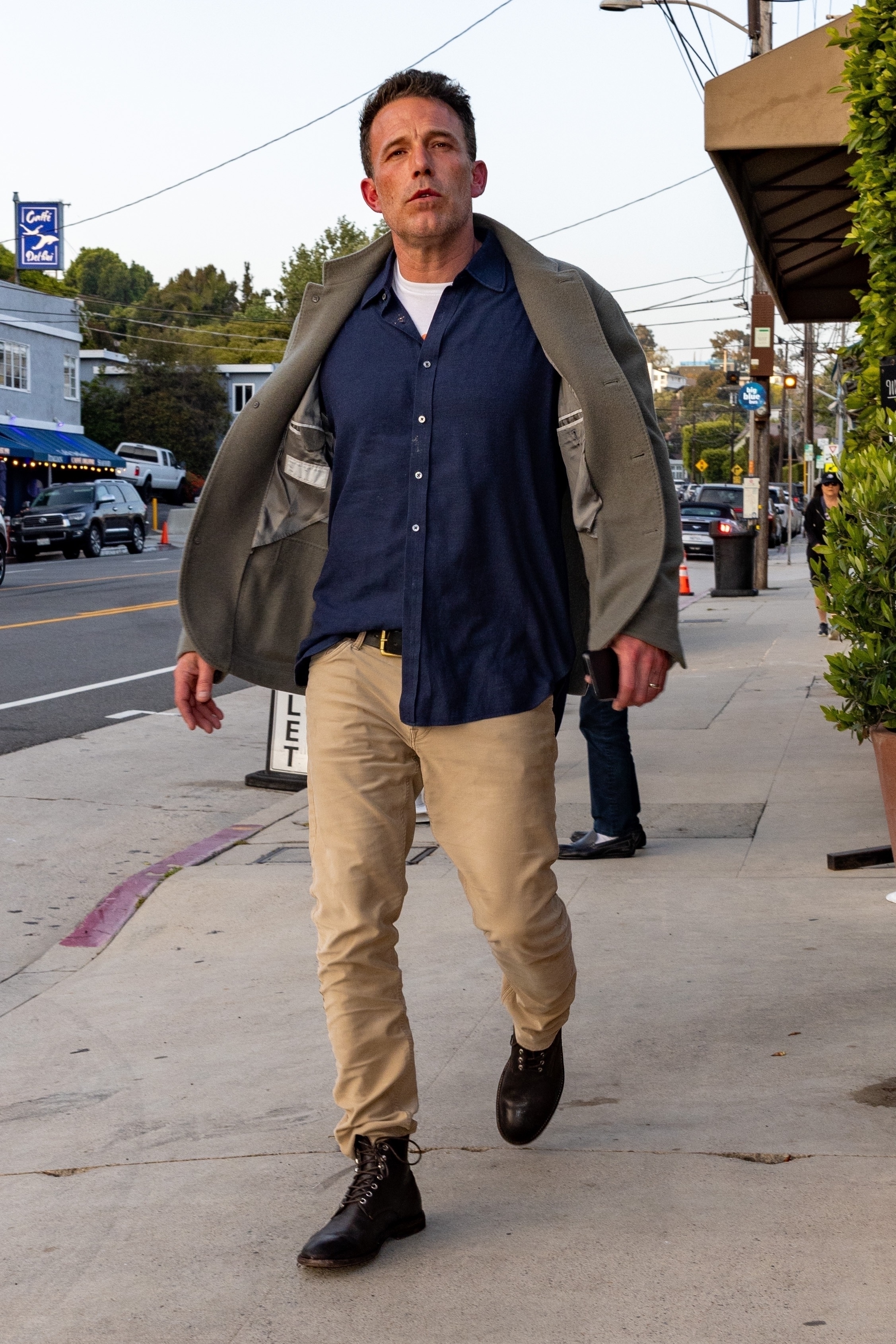 The actor looked very solemn as he walked to the restaurant alone