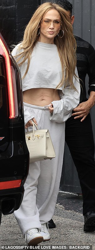 The 54-year-old was spotted emerging from a dance studio in a flowing grey crop top with long sleeves that fell over her fingers