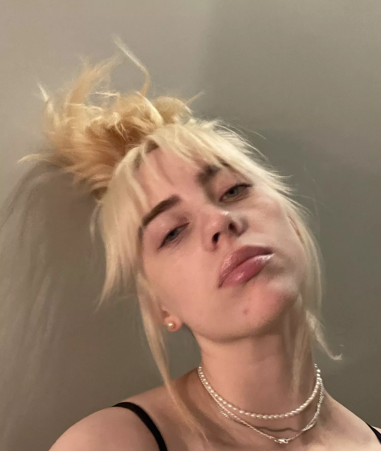 Billie Eilish in a messy topknot