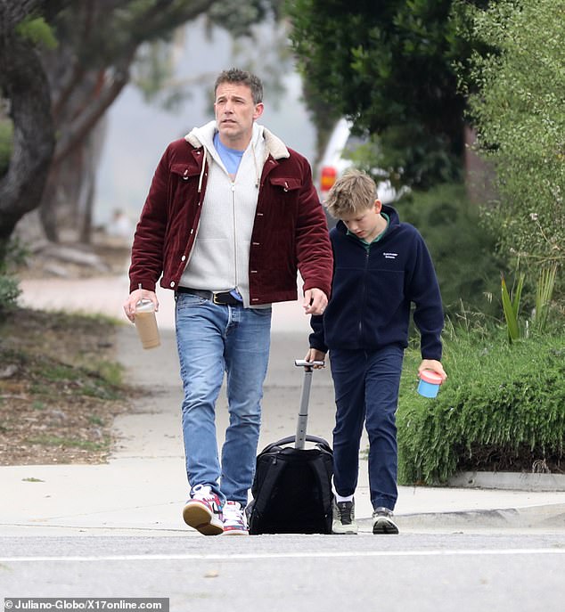 While doing the morning drop-off at his 12-year-old's school, the 51-year-old Oscar winner looked a bit exhausted as he carried an iced coffee in one hand for a much-needed pick-me-up