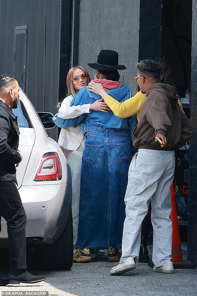 After sliding out of the passenger side of a white car, the two-time Grammy nominee exchanged friendly hugs with several members on her team